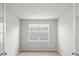 Bright, empty bedroom featuring a window and light-colored wood-look flooring at 11520 Myakka Blue Dr, Venice, FL 34293