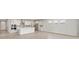 Modern kitchen with stainless steel appliances, island, sleek countertops, and ample cabinet space at 11520 Myakka Blue Dr, Venice, FL 34293