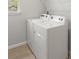 Laundry room featuring a white washer and dryer set and tile flooring at 11520 Myakka Blue Dr, Venice, FL 34293