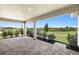 Relax on the covered patio with brick pavers and enjoy peaceful views of the lush green backyard at 11520 Myakka Blue Dr, Venice, FL 34293