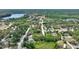 Captured from above, a charming neighborhood next to a road and interspersed with green spaces and a body of water at 11940 Terra Ceia Ave, New Port Richey, FL 34654
