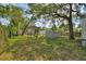 Spacious fenced backyard with mature trees providing shade and privacy at 11940 Terra Ceia Ave, New Port Richey, FL 34654