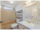 Bathroom with a tub and shower, single vanity, and patterned wallpaper at 11940 Terra Ceia Ave, New Port Richey, FL 34654