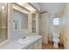 Bathroom featuring a large mirror, wallpaper, and a white toilet at 11940 Terra Ceia Ave, New Port Richey, FL 34654