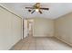 Comfortable bedroom featuring a spacious closet and tile flooring, perfect for a relaxing retreat at 11940 Terra Ceia Ave, New Port Richey, FL 34654