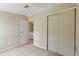 Simple bedroom showcasing tile floors and a closet, with laundry in the hall at 11940 Terra Ceia Ave, New Port Richey, FL 34654