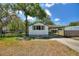 Charming single-story home featuring large windows and a covered carport at 11940 Terra Ceia Ave, New Port Richey, FL 34654