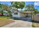 Well-maintained single-story home with a concrete driveway and attached carport at 11940 Terra Ceia Ave, New Port Richey, FL 34654