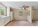 Another view of the bright kitchen featuring white cabinets and tile floors at 11940 Terra Ceia Ave, New Port Richey, FL 34654
