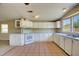 Spacious kitchen with white cabinets, tile flooring, and ample counter space at 11940 Terra Ceia Ave, New Port Richey, FL 34654
