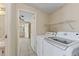 Laundry room with modern washer and dryer units, conveniently located next to bathroom at 11940 Terra Ceia Ave, New Port Richey, FL 34654
