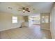 View of the open-concept living room and kitchen with tile flooring and neutral paint at 11940 Terra Ceia Ave, New Port Richey, FL 34654