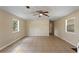 Spacious living room featuring tile floors and natural light from multiple windows at 11940 Terra Ceia Ave, New Port Richey, FL 34654