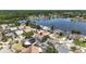 Picture of a beautiful home in a residential area with a lake nearby, a pool, and solar panels at 12002 Peony Ct, Tampa, FL 33635
