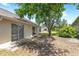 Sliding glass doors lead to the outdoor patio, shaded by a mature tree in the backyard at 12002 Peony Ct, Tampa, FL 33635