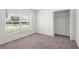 Comfortable bedroom with a large window and closet space at 12002 Peony Ct, Tampa, FL 33635
