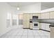 Spacious kitchen featuring plenty of storage and white appliances at 12002 Peony Ct, Tampa, FL 33635