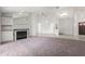 Spacious living room featuring a fireplace, mirrored wall, and open layout flowing into the kitchen and dining areas at 12002 Peony Ct, Tampa, FL 33635