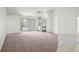 Bright and airy living room featuring neutral carpet, a ceiling fan, a mirrored wall, and a fireplace at 12002 Peony Ct, Tampa, FL 33635