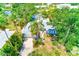 Charming home boasts lush tropical landscaping, a sparkling pool, and serene water views at 127 Lake Judy Lee Dr, Largo, FL 33771
