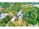Aerial view showcasing the home's proximity to a serene pond and lush surroundings at 127 Lake Judy Lee Dr, Largo, FL 33771
