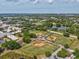 Aerial view of baseball fields in a well-maintained community with water and trees at 128 Brandy Wine Dr, Largo, FL 33771