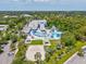 Aerial view of the community recreation center featuring tennis, pool, volleyball, and parking at 128 Brandy Wine Dr, Largo, FL 33771