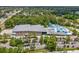 Aerial view of the community recreation center featuring tennis, pool, and parking at 128 Brandy Wine Dr, Largo, FL 33771