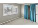 This bedroom features a neutral color scheme, plush carpeting, a bright window and a closet with curtains at 128 Brandy Wine Dr, Largo, FL 33771