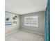 Bedroom with carpet, neutral paint, and a large window with white shutter blinds at 128 Brandy Wine Dr, Largo, FL 33771