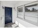 Entrance to unit 128 featuring a blue front door, white trim, and tiled entryway at 128 Brandy Wine Dr, Largo, FL 33771