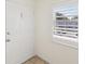 A view of the interior side of the front door and the shuttered window in the entry hall at 128 Brandy Wine Dr, Largo, FL 33771