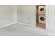 A conveniently located laundry area equipped with a stacked washer and dryer unit for efficient space utilization at 128 Brandy Wine Dr, Largo, FL 33771