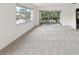 Spacious living room featuring neutral paint, large windows, and sliding glass doors leading to the outside at 128 Brandy Wine Dr, Largo, FL 33771