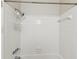 The bathroom features a pristine white tiled shower with a detachable shower head and caddy for toiletries at 128 Brandy Wine Dr, Largo, FL 33771