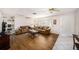 Well-lit living room featuring modern furnishings, wood-look flooring, and white walls at 12848 137Th Ln, Largo, FL 33774