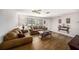 Bright living room with wood-look flooring, neutral paint, and comfortable seating at 12848 137Th Ln, Largo, FL 33774