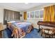 Cozy bedroom with natural light, desk, and a comfortable bed with a colorful quilt at 1301 62Nd S Ter, St Petersburg, FL 33705