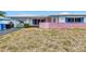 Single-story home featuring a front yard with a painting on the garage door at 1301 62Nd S Ter, St Petersburg, FL 33705