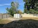 Spacious backyard with a storage shed, a well-maintained lawn, and a tall privacy fence at 13018 Clay Ave, Largo, FL 33773