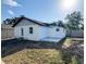 Exterior view of the home showcases a well-kept backyard with patio and privacy fence at 13018 Clay Ave, Largo, FL 33773
