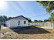 Expansive backyard features a well-maintained lawn, a privacy fence, and a patio area at 13018 Clay Ave, Largo, FL 33773