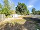 Spacious backyard featuring a storage shed, concrete slab and partial fencing at 13018 Clay Ave, Largo, FL 33773