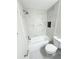 Bright bathroom featuring a tub with marble tile surround and built-in shower niche at 13018 Clay Ave, Largo, FL 33773