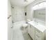 Updated bathroom featuring modern fixtures, vanity, white tile, and tub with shower at 13018 Clay Ave, Largo, FL 33773