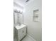 Bathroom featuring modern vanity, mirror, and built-in shelving at 13018 Clay Ave, Largo, FL 33773