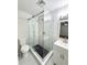 Updated bathroom with marble tile, glass enclosed shower, and modern vanity at 13018 Clay Ave, Largo, FL 33773