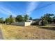 Single-story home with a neutral-colored fence and tropical landscaping in a residential neighborhood at 13018 Clay Ave, Largo, FL 33773