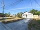 Inviting single-story home boasts a long driveway, attached garage, and is surrounded by a lush landscape at 13018 Clay Ave, Largo, FL 33773