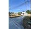 Inviting single-story home with a long drive, attached garage, lush landscape, and well-maintained lawn at 13018 Clay Ave, Largo, FL 33773